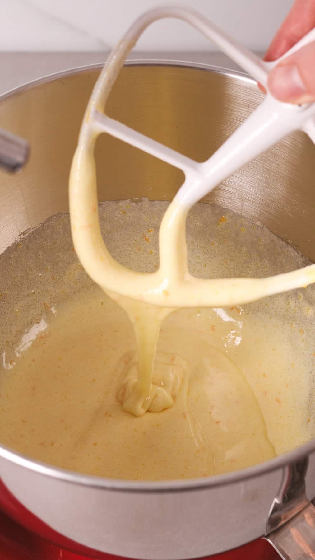A pale and light and fluffy batter in a stand mixer.